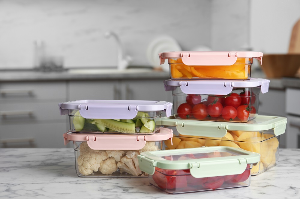 sliced vegetables in containers on a kitchen counter