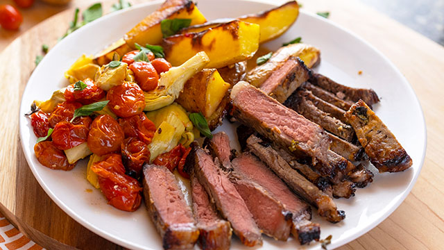 Greek Sheet-Pan KC Strip Steak with Roasted Tomatoes, Artichokes & Fingerlings