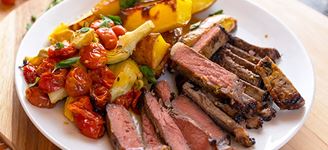 Greek Sheet-Pan KC Strip Steak with Roasted Tomatoes, Artichokes & Fingerlings